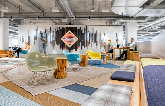 Livefyre offices, featuring wide common areas, meeting rooms with transparent walls and ample light, and a wall streaming a live feed of real-time postings, embodying the now orientation of the technology companys services (San Francisco, California, 2014). Photo: Jasper Sanidad
